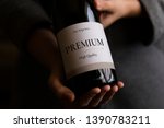 Woman holding a bottle of wine with a label mockup