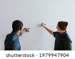 People Writing On A White Wall...