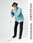 Small photo of Blind senior man with a cane walking