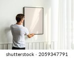 blank frame being hung by a... | Shutterstock . vector #2059347791