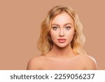 Beautiful Woman Face close up studio on peach background. Makeup. Beauty Portrait of female Face with smokey eyes and arrows, beautiful natural plump lips. Isolated                     