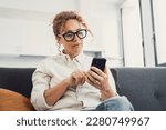 Excited happy young adult woman reading message on mobile phone, getting good news on screen, smiling, laughing, talking on video call, chatting on Internet, using online app. Communication concept