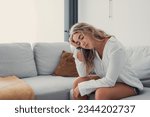 Small photo of Depressed or tired teen girl feeling stress headache hurt pain sitting alone at home, upset sad heartbroken young woman regret pregnancy or abortion, troubled with problem or psychological trauma