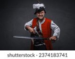 Small photo of A menacing pirate with a gray beard dressed in white attire and a red vest, holding a musket and sword, preparing for combat against a textured backdrop