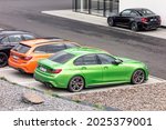 Small photo of OSTRAVA, CZECH REPUBLIC - MAY 19, 2021: The modern bright green BMW M340i saloon vehicle and other BMWs at the dealership ready for test drive