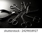 Small photo of Manicure set of tools made of steel isolated scattered around on black background, scissors, cutter nozzles and nail nippers