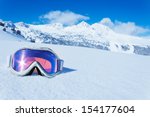 Ski and snowboard mask in the snow with copy space and mountain on background