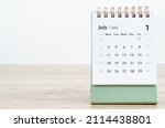 The July 2022 desk calendar on wooden background.