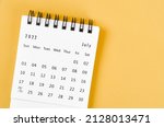 The July 2022 desk calendar on light yellow background.