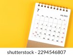 July 2023 Monthly desk calendar for 2023 year on yellow background.