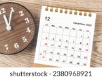 December 2023 Monthly desk calendar for 2023 year with wooden clock.