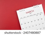 March 2024 desk calendar on red ...