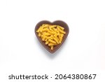 pasta isolated on white background. pasta is laid out in the shape of a heart. durum flour products