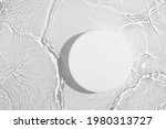 Small photo of Empty white circle podium on transparent clear calm water texture with splashes and waves in sunlight. Abstract nature background for product presentation. Flat lay cosmetic mockup, copy space.