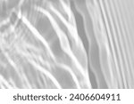Small photo of Blurred defocused water texture overlay effect for photo and mockups. Organic drop diagonal shadow and light caustic effect on a white wall. Shadows for natural light effects
