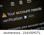 Small photo of Email notification to verify new account opening in order to complete identity verification as part of KYC and AML policies. ID verification required for new crypto account. Phone screen, macro view.