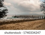 Small photo of The pier on the empty sand beach at sunset at NusaBay Menjangan by WHM in Bali