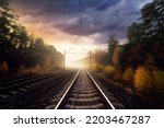Railroad in the autumn forest. Railway tracks through the forest. Motion blur effect.