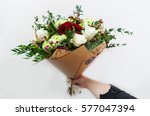 Woman hand holding flowers. Bouquet of flowers for congratulations.