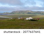 Small photo of Vik, Iceland - August 12th 2021: Grassy landscape with mountains water and meadow near the Black Sand Beach Vik Iceland