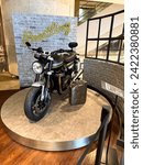 Small photo of Singapore, Jan 26, 2024. A new Breitling Boutique design as an industrial loft. British motorcycle Triumph on display.