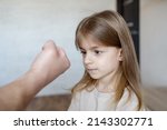 Small photo of Violence against children. Father scolds and threaten her child girl. family relationships. Discipline, yelling, spanking concept.