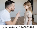 Small photo of family relationships. Discipline, yelling, spanking concept. Focus on girl.