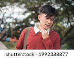 Small photo of A young male call center agent or teacher tries to soothe his scratchy throat. Sore or dry throat caused by fatigue or disease.