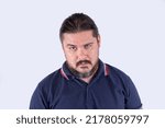 Small photo of A groggy man in his late 30s. Possibly drunk with a hangover, or sleep deprived. A state of tiredness looking a bit funny. Isolated on a white background.