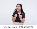 Small photo of An excited young woman pumping both her fists, giddy with anticipation and energy. Isolated on a white backdrop.