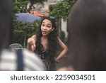 Small photo of An self-entitled and mean young woman lectures and berates two poor women about their looks and social status.