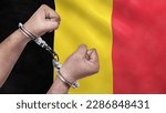 Small photo of A man getting under arrest in Belgium. Concept of being handcuffed, detained, incarcerated and jailed in said country. National law enforcement concept.