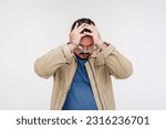 Small photo of A stressed man in handcuffs under duress. Under arrest and detained for a suspected crime. Isolated on a white background.