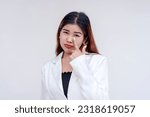 Small photo of A sarcastic young woman pulling her lower eyelid with a finger to mock someone. Making fake tears to taunt. Isolated on a white background.