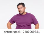 Small photo of A wary middle aged man looks at someone with suspicioun. Wearing a purple waffle shirt, Isolated on a white background.