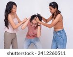 Small photo of Playful Friends Tugging on Man's Hair in Jest. Three friends joking around in a playful tussle. Isolated on a white background.