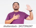 Small photo of A peaceful man in a purple shirt with a raised hand exudes tranquility and calmness, illustrating a moment of silence or meditation. Swearing fealty.