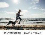 Girl Runs With Her Dog On The...
