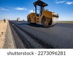Small photo of Kyzylorda province, Kazakhstan, April 29, 2012: Construction of West Europe-West China highway. Caterpillar asphalt compactor flatten asphalt
