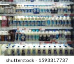 Small photo of Blur Supermarket sale milk bottles or milk section on shelves background, Many milk bottles sale on the shelf in a supermarket, as blurted effect background, milk section.