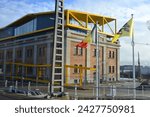 Small photo of Ostend, West-Flanders, Belgium - February 17, 2024: Entrepot-Stapelhuis shooting from inside a tram on a red brick bonded warehouse with yellow steel roof structure