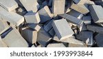 Small photo of Gray paving stones. Background of sidewalk tiles in a disharmonious arrangement