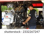 Small photo of Greenfield, Wisconsin USA - July 15th, 2023: Motorcycle repair mechanics repaired motorcycles at Harley Davidson Rally.