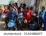 Small photo of Palestinians receive a ration of food, which was distributed to poor families, during the holy month of Ramadan, in Rafah, southern Gaza Strip,, on April 4, 2022.