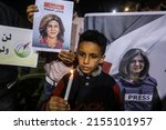 Small photo of Palestinians take part in a candlelight vigil to condemn the killing of veteran Al Jazeera journalist Shireen Abu Aqleh, in Rafah, in the southern Gaza Strip, on May 11, 2022.