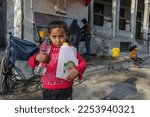 Small photo of Palestinians fill bottles of water for home consumption from a public fountain, at the Rafah refugee camp in the southern Gaza Strip, on January 25, 2023.