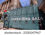 Small photo of Palestinian refugees gather with national flags outside the United Nations Relief and Works Agency (UNRWA) in Gaza City on June 20, 2023, to protest cuts in aid.