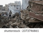 Small photo of People search the Khan Yunis municipality building after an Israeli air strike, in the city of Khan Yunis, southern of the Gaza Strip, October 10, 2023.