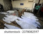 Small photo of Palestinians wait to receive the bodies of their relatives who were killed in an Israeli air strike, at Al-Najjar Hospital, in the southern Gaza Strip, on October 21, 2023.