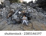 Small photo of Palestinians inspect their destroyed house after an Israeli air strike, in the city of Rafah, south of the Gaza Strip, on November 7, 2023.